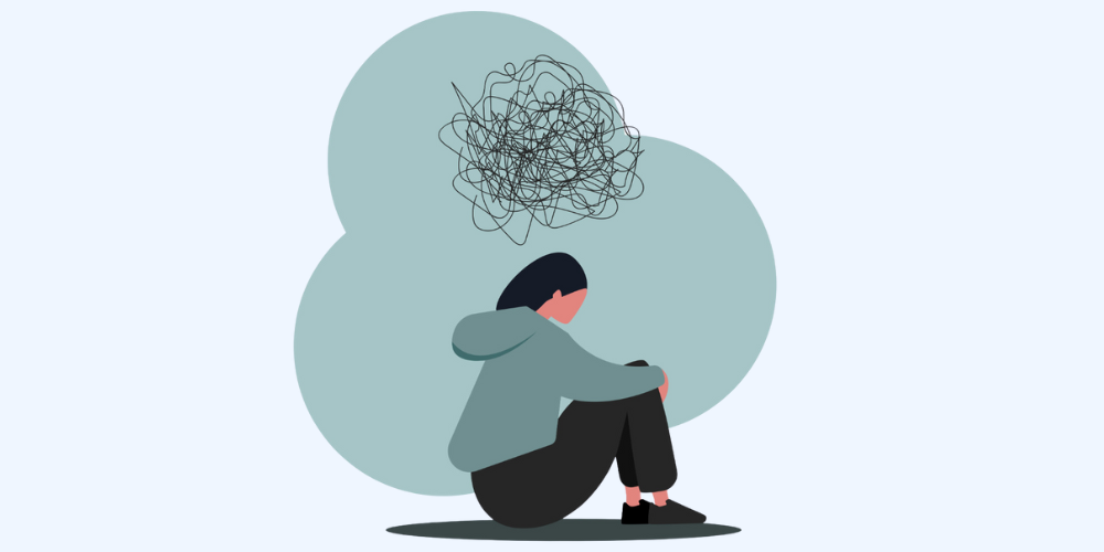 personal sitting on the ground with a tangled mess of thoughts hovering above them