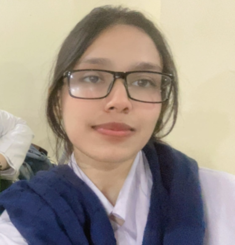Woman with glasses wearing a white shirt and a blue sweater