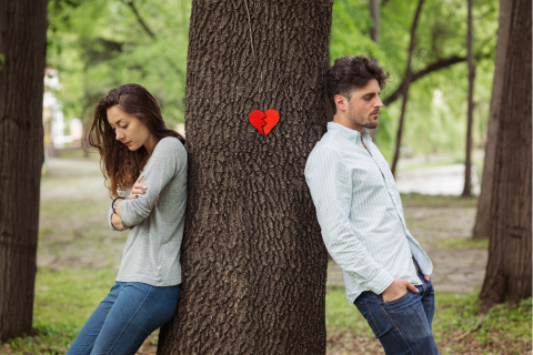 man and woman standing by tree
