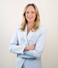 Photo of Corinne Menn in blue suit